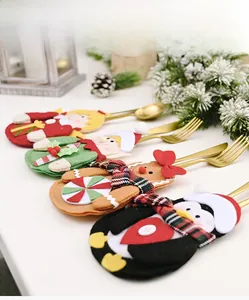Detail of Christmas felt cutlery holders with elf, gingerbread man and penguin designs