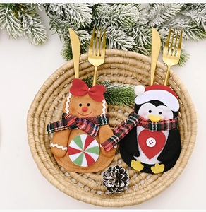 Detail showing gingerbread man and penguin felt cutlery holders with festive Christmas decor
