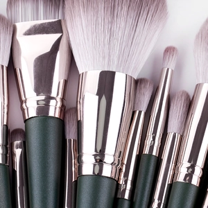 14-piece green cloud makeup brush set with rose gold tubes and soft synthetic bristles