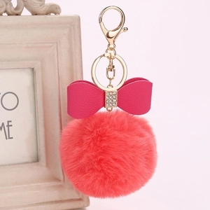 Pink faux fur ball keychain with rhinestone bow and gold metal ring for bags