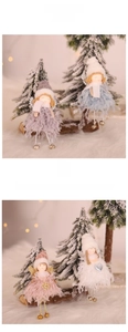 Detail of plush Christmas angel ornaments with mini bells and glittery wings on tree