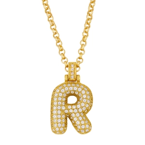 Close-up of gold-plated iced out bubble letter R pendant with sparkling crystals