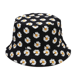 Reversible daisy bucket hat in black with all-over white floral print for sun protection