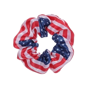 Detailed close-up of a fabric scrunchie with a classic US flag stars and stripes pattern