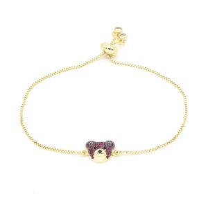 Detail of adjustable gold bear bracelet with ruby-colored micro-pave crystals