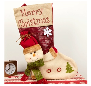 Detail of Christmas stocking featuring a 3D snowman doll and snowflakes on jute fabric
