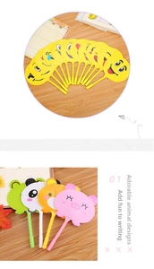 Detailed view of creative cartoon animal and emoji fan pens on a wooden desk