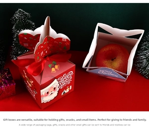Detailed view of red Christmas apple boxes with festive Santa prints and satin ribbons