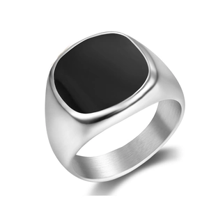 Close-up of a silver stainless steel signet ring with a black square top and brushed finish