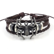 Detailed macro shot of adjustable braided leather bracelet with central metal spider charm