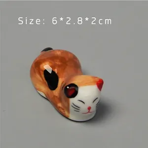 Macro detail of hand-painted calico ceramic cat chopstick rest sized 6x2.8x2cm