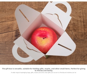 Top view of white cardboard Christmas apple box with handles and secure buckle
