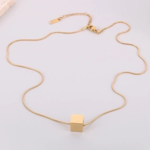 Minimalist gold cube pendant necklace with sleek snake chain on a white background