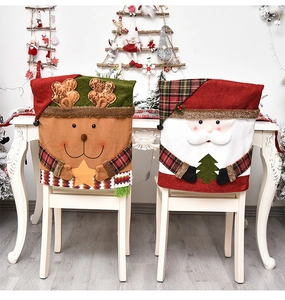 Detail of Santa and reindeer chair covers with 3D plush doll designs for Christmas decor