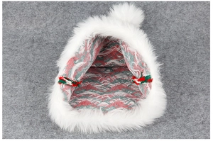 Macro detail of red and green knitted patterns with premium white plush trim on Santa hat