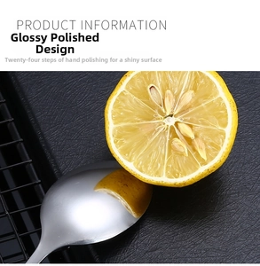 Macro view of mirror polished stainless steel spoon with clear lemon reflection