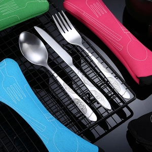 Stainless steel cutlery set with knife fork spoon and colorful storage bags on dark background