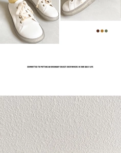 Detail of white leather round toe sneakers with cream laces and durable anti-slip gum soles