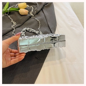 Silver acrylic box bag with wrinkled metallic texture and chunky silver chain handle