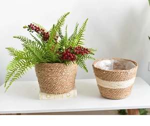 Detail of hand-woven cylindrical straw planters with natural textures and white accents
