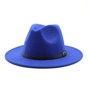 Detail of royal blue wool fedora hat featuring a brown leather band and metal buckle