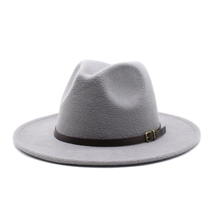 Detail of grey wool felt fedora with a brown leather band and gold metal buckle trim