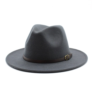 Detail of dark grey wool fedora hat featuring a brown leather band and gold metal buckle