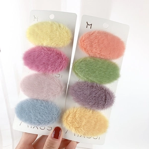 Close-up of colorful plush oval BB hair clips on display cards in various soft pastel colors