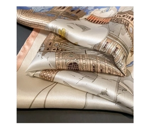 Macro detail of silk scarf showing vintage architectural prints and fine rolled edges