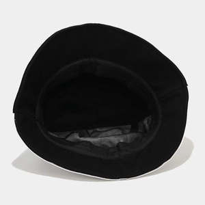 Detailed interior view showing high-quality stitching on black cotton bucket hat