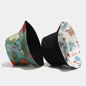 Detail of reversible bucket hat with ocean plants print and blue floral graphics