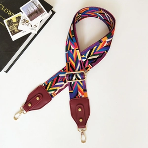 Ethnic style colorful woven bag strap with red PU leather ends and gold metal hooks