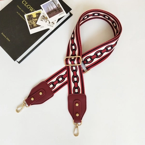 Close-up of adjustable wide shoulder strap with red white and black chain pattern