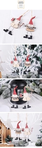 Detail of Nordic wooden Christmas gnome ornaments with red striped hats and spring legs