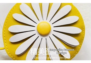 Detail showing 3D daisy flower on yellow PU leather bag with lychee texture finish