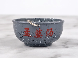 Detail of retro splattered enamel bowl keychain featuring red Mengpo Soup calligraphy