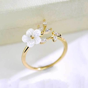 Elegant gold open ring featuring white shell flower and sparkling crystal leaves