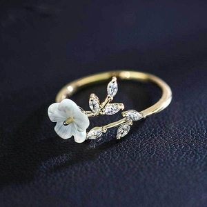 Elegant gold flower and leaf ring with white shell petals and sparkling zircon stones