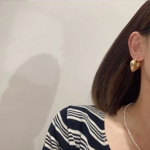 Pendientes de corazón hueco en latón chapado en oro pulido usados en la oreja