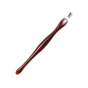 Detail view of nail cuticle trimmer with ergonomic amber resin handle and V-shaped metal tip