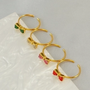 Adjustable gold bow rings set with colorful rhinestones in four vibrant colors