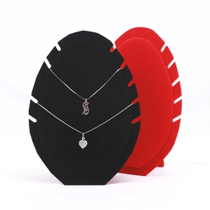 Detail of black and red velvet flame-shaped necklace display stands with multiple slots