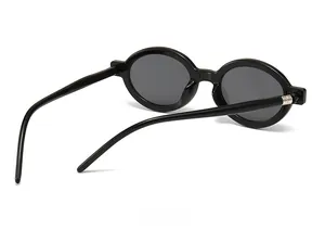 Detail view of the black oval sunglasses frame showing hinges and white size model numbers