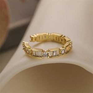 Close-up of golden heart ring featuring micro-pave cubic zirconia on an open band