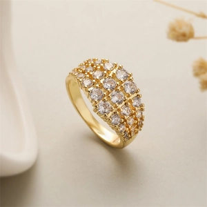 Macro shot of gold multi-layer wide band ring with shimmering cubic zirconia inlay
