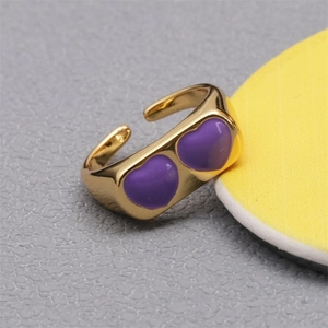 Adjustable gold ring with double purple heart enamel patterns on textured background
