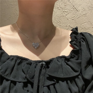 Minimalist heart pendant necklace with zircon crystals shown on model for elegant styling