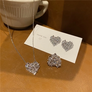 Sparkling zircon heart jewelry set including necklace, earrings, and open ring on leather