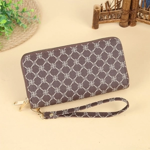 Detail of long brown floral print leather wallet with dual zippers and hand strap