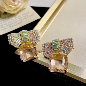 Elegant pink bow crystal earrings with rectangular champagne pendants in luxury gold finish
